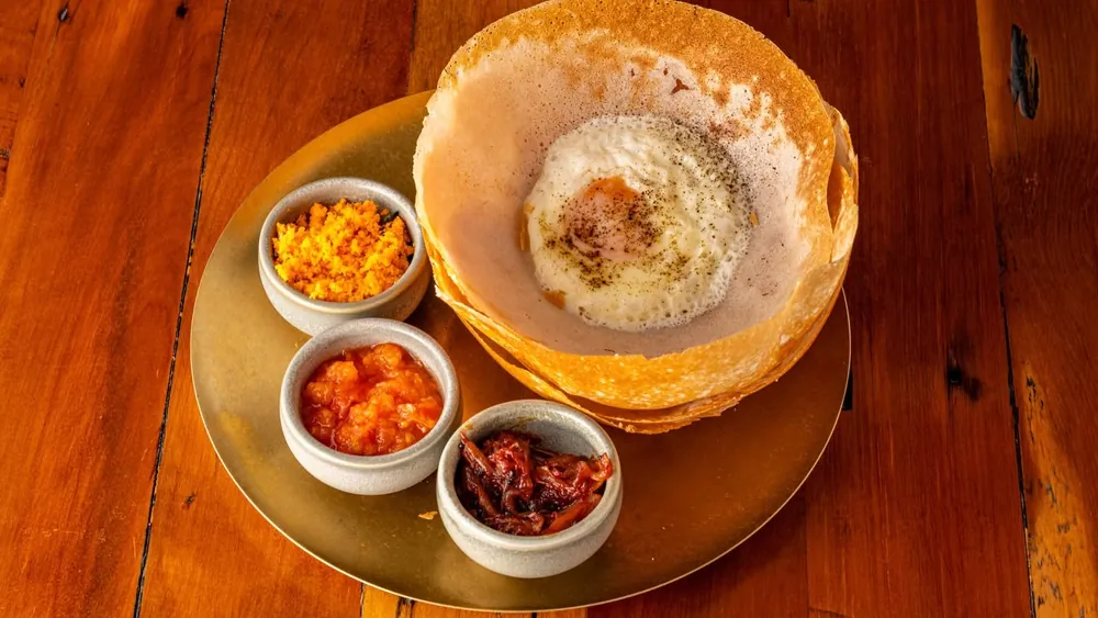 Egg hopper served with three sambols