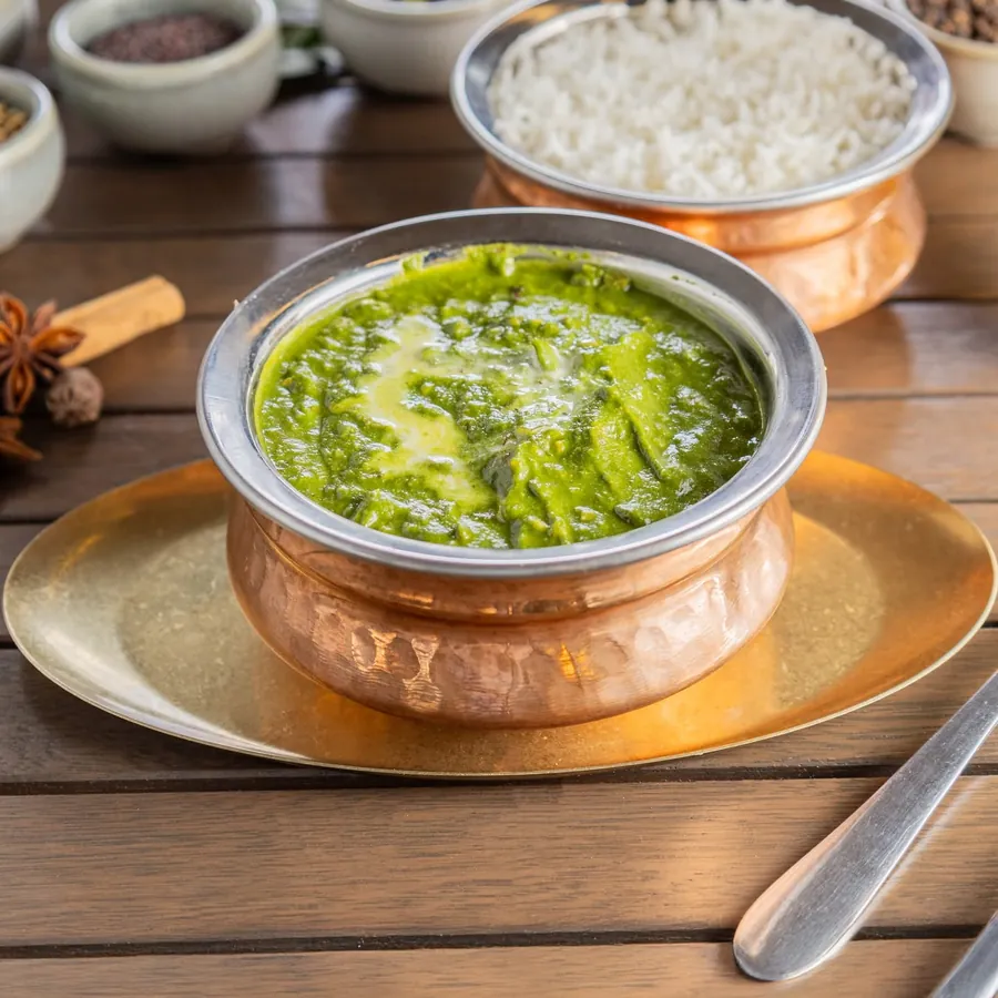 Palak spinach curry in a copper handi