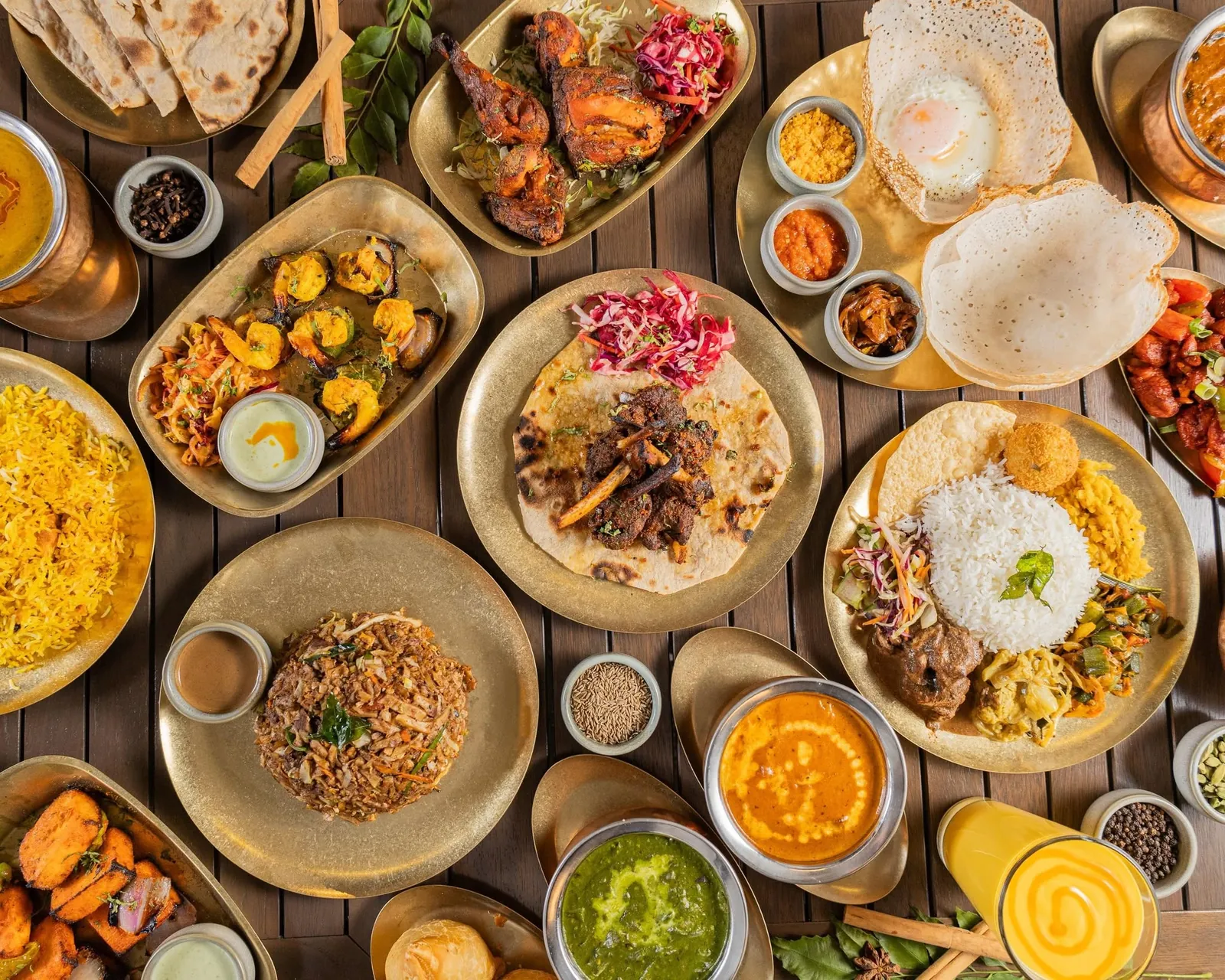 Flat lay of hoppers, kottu, biryani, curries and tandoori